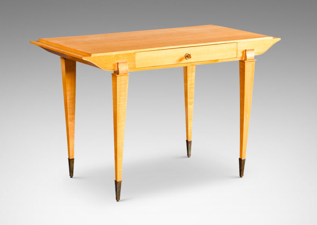 Gallery BAC top case with drawer and contoured sides, on tapered legs capped with tall sabots