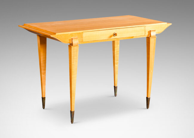 Gallery BAC top case with drawer and contoured sides, on tapered legs capped with tall sabots