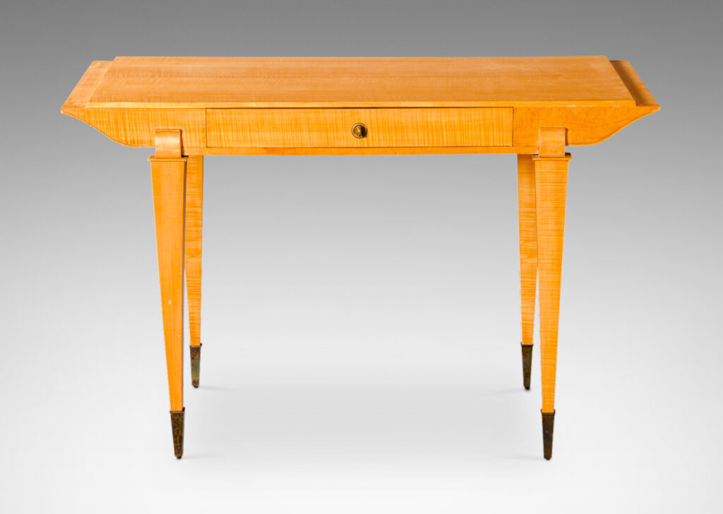 Gallery BAC top case with drawer and contoured sides, on tapered legs capped with tall sabots