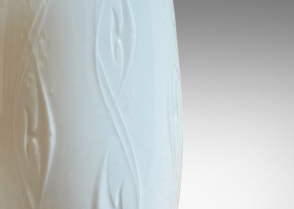 Gallery BAC tall tapering ovoid bases with swirling motifs in white glazed porcelain