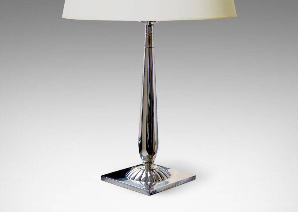 Gallery BAC column balanced on a smooth spherical fob on a square plinth with a large repoussé rosette in the center