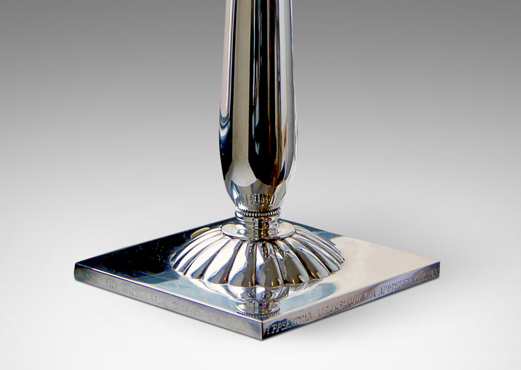 Gallery BAC column balanced on a smooth spherical fob on a square plinth with a large repoussé rosette in the center