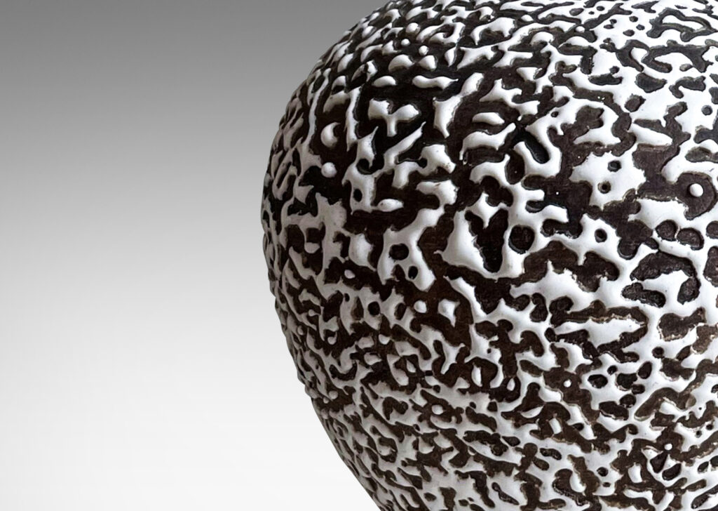 Gallery BAC angled and tapred globe forms in “crispé” beaded white over matte brown glazing