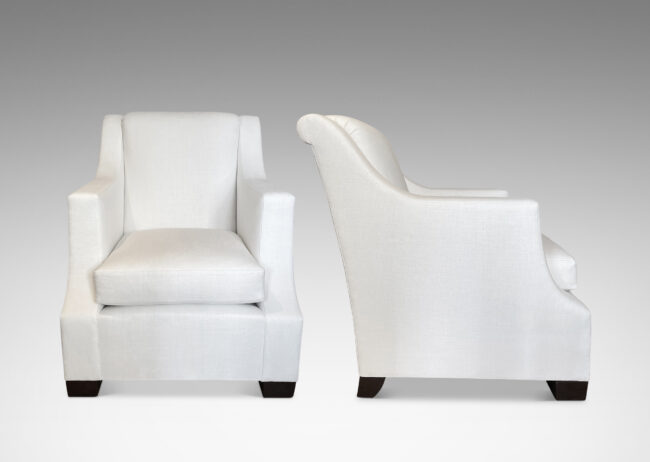 Gallery BAC armchairs having tailored orthogonal lines offset by a dramatic scrolled back and cove arm rests