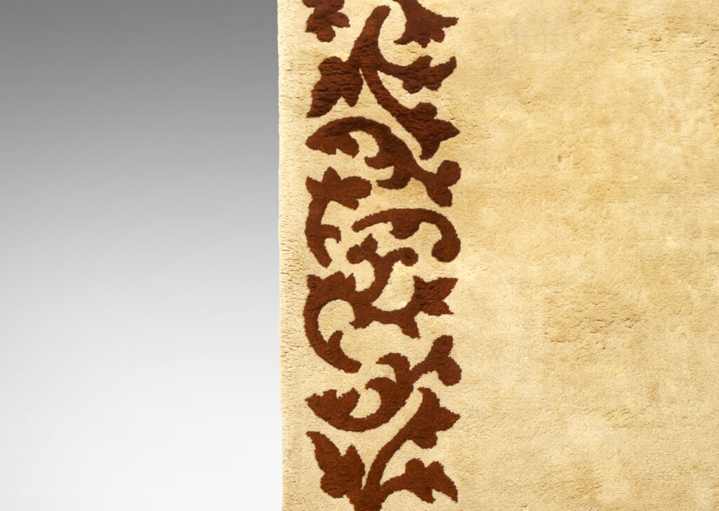 Gallery BAC carpet in two shades of brown, with sculpted foliate border