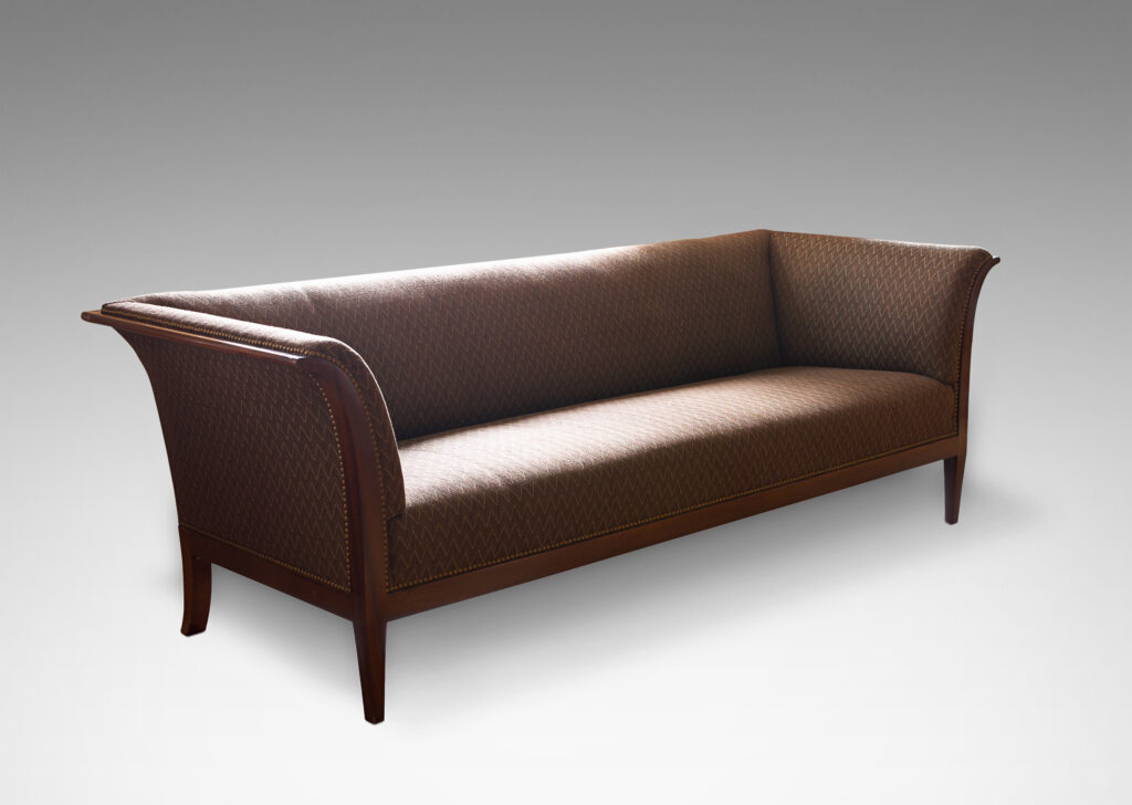 Gallery BAC sofa with graceful curve in Cuban mahogany