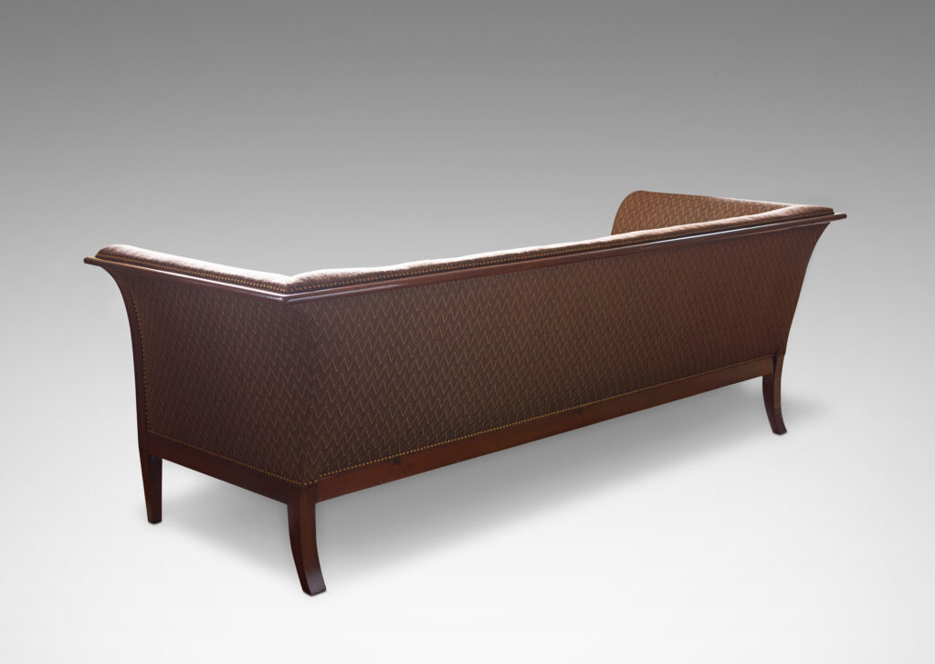 Gallery BAC sofa with graceful curve in Cuban mahogany