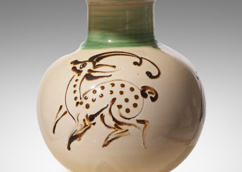 Gallery BAC globe form with neck and reveal footing, in earthenware glazed in ivory with quill painted deer figure in brown