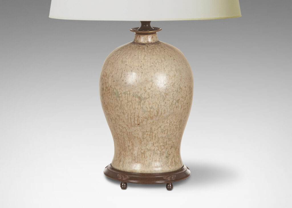 Gallery BAC flared oval bell form in stoneware masterfully glazed in softly dappled pale gray and sand tones, with patinated cast bronze base and collar with filigree details