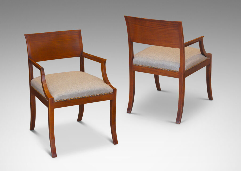 Gallery BAC klismos-style back rail, sabered legs, and arms having cavetto fronts, in Cuban mahogany