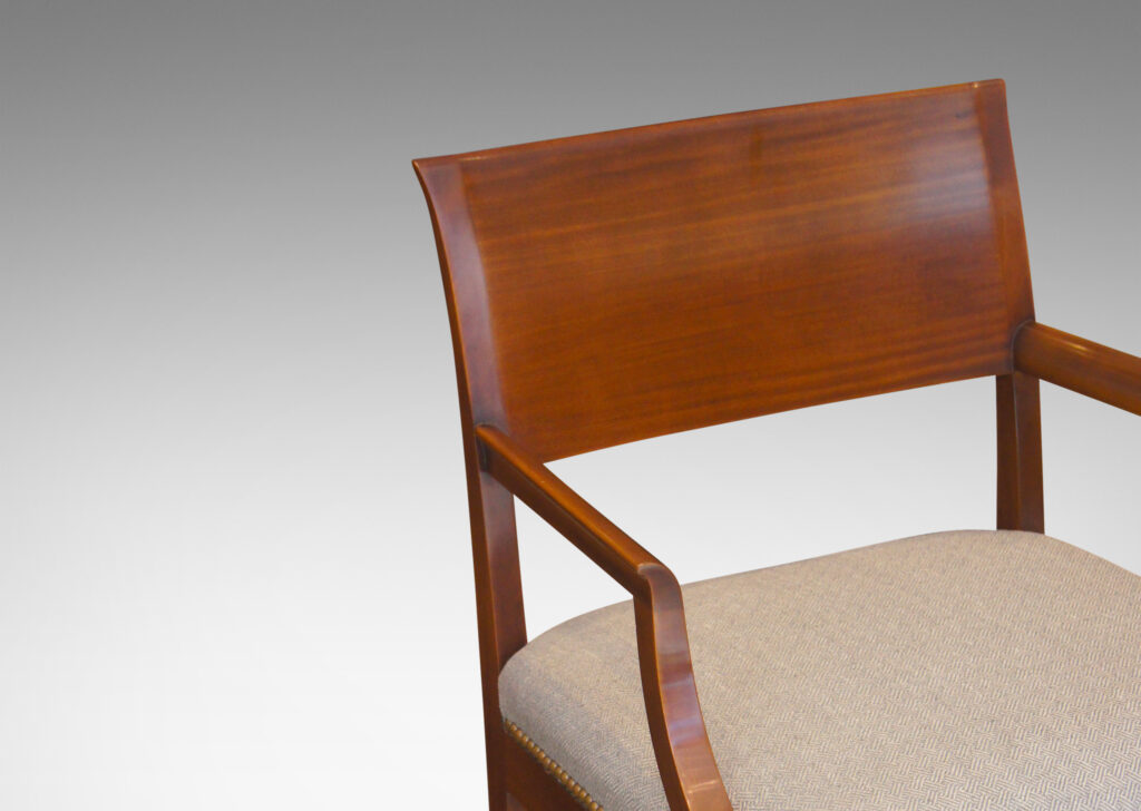 Gallery BAC klismos-style back rail, sabered legs, and arms having cavetto fronts, in Cuban mahogany