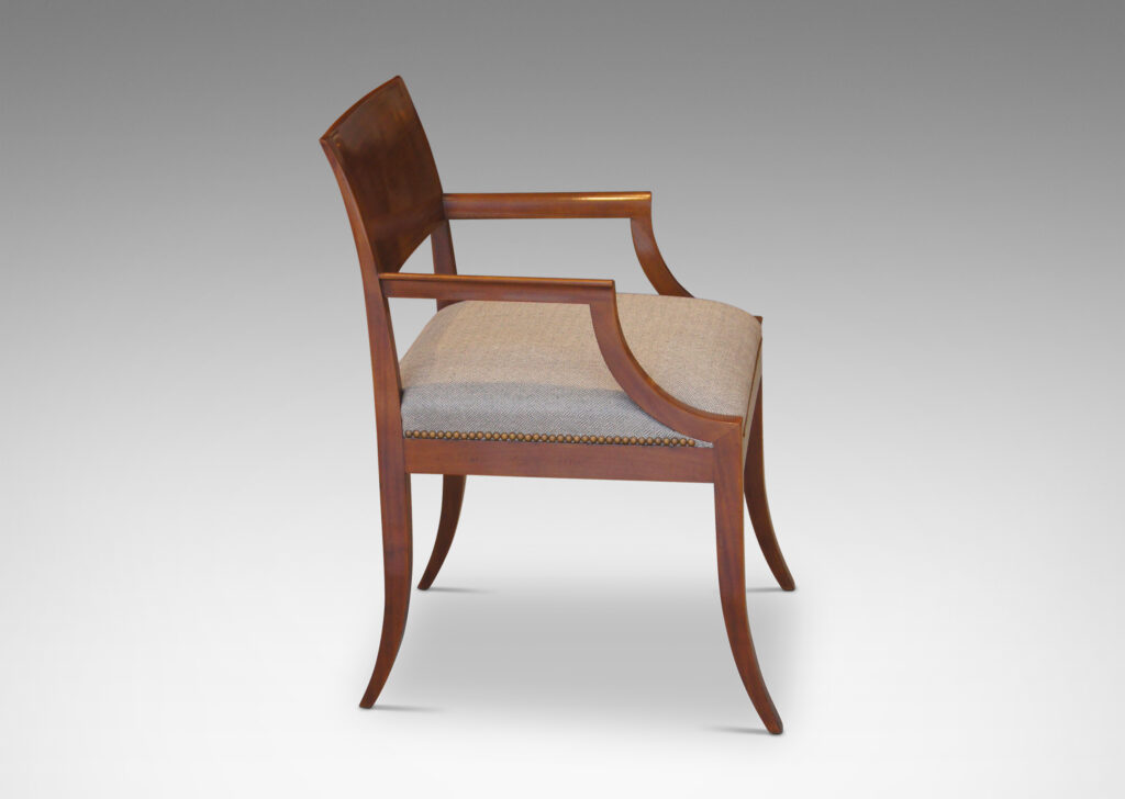 Gallery BAC klismos-style back rail, sabered legs, and arms having cavetto fronts, in Cuban mahogany