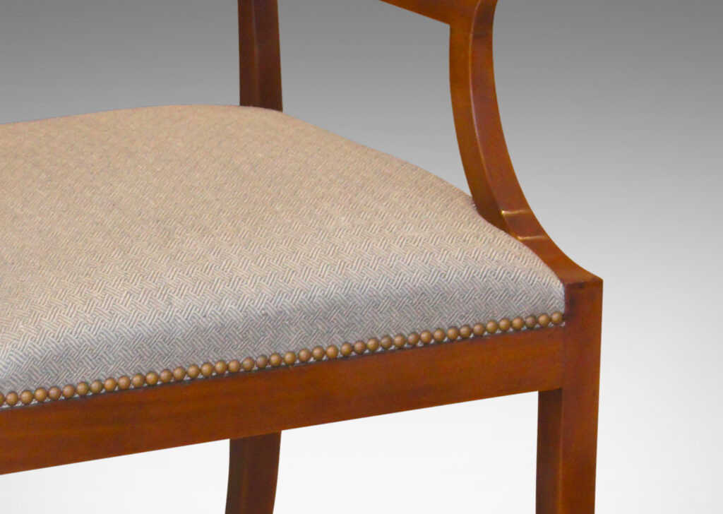 Gallery BAC klismos-style back rail, sabered legs, and arms having cavetto fronts, in Cuban mahogany