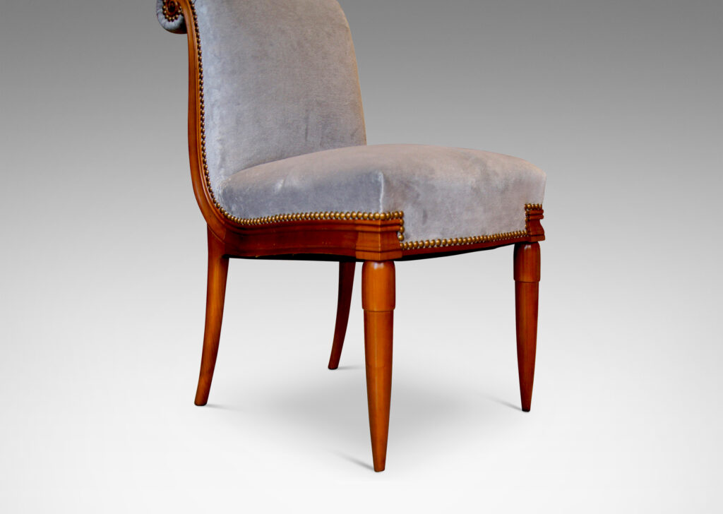 Gallery BAC solid cuts of cherry with carved detailing, having two round tapering front legs with tassel shaped tops and sabered back legs and S-form frame with rolled back