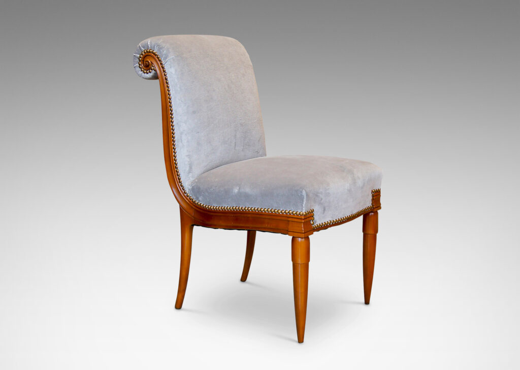 Gallery BAC solid cuts of cherry with carved detailing, having two round tapering front legs with tassel shaped tops and sabered back legs and S-form frame with rolled back