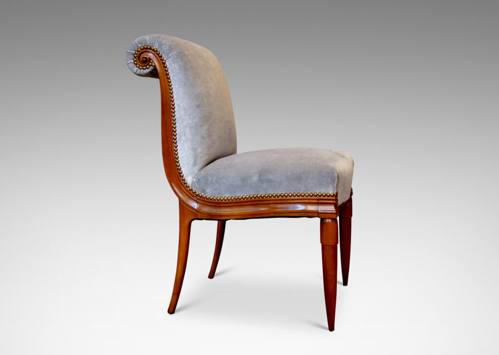 Gallery BAC solid cuts of cherry with carved detailing, having two round tapering front legs with tassel shaped tops and sabered back legs and S-form frame with rolled back