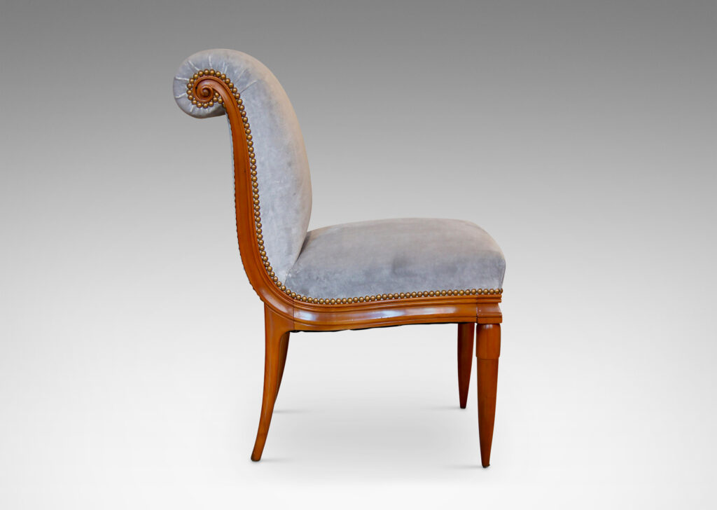 Gallery BAC solid cuts of cherry with carved detailing, having two round tapering front legs with tassel shaped tops and sabered back legs and S-form frame with rolled back