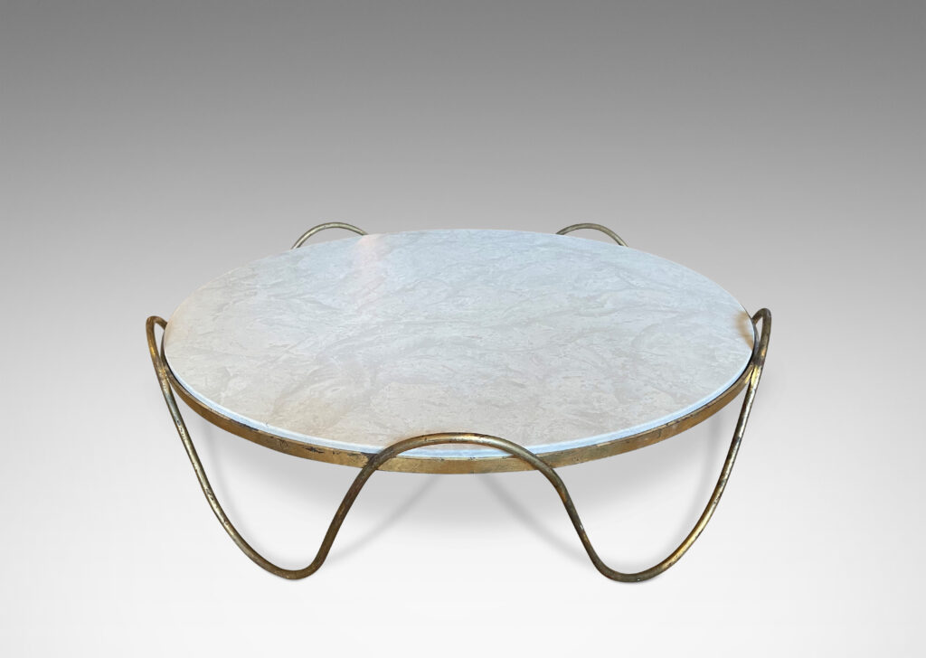 Gallery BAC round limestone top held aloft by an encircling continuous wave of gilded iron