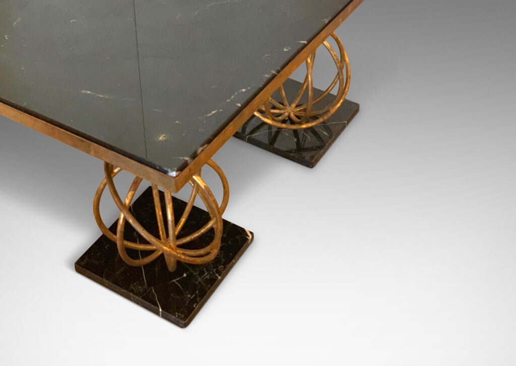 Gallery BAC coffee table by Jean Royère, having a rectangular black marble top supported on four “Sphère” motif legs