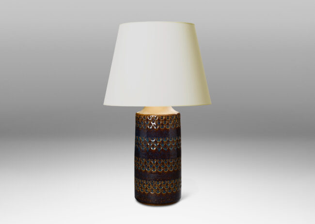 Gallery BAC Tall table lamp having a clyindircal / bottle form with impressed running U forms