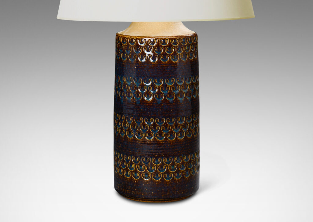 Gallery BAC Tall table lamp having a clyindircal / bottle form with impressed running U forms