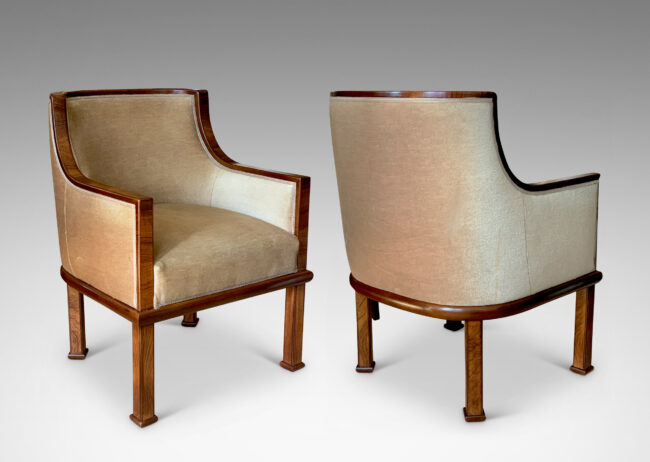 Gallery BAC club chairs, having curved backs with coved armrests, framed in a band of mahogany