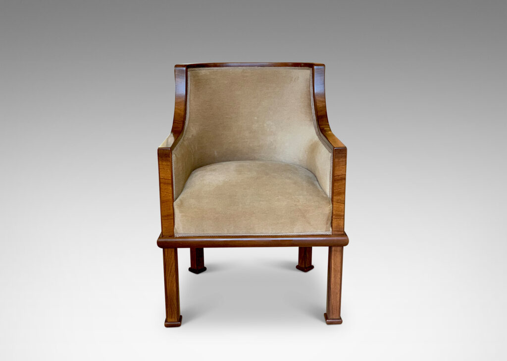 Gallery BAC club chairs, having curved backs with coved armrests, framed in a band of mahogany