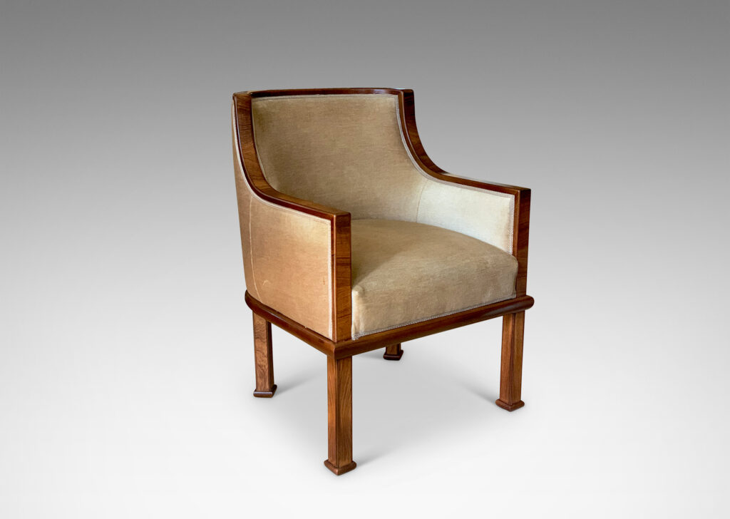 Gallery BAC club chairs, having curved backs with coved armrests, framed in a band of mahogany