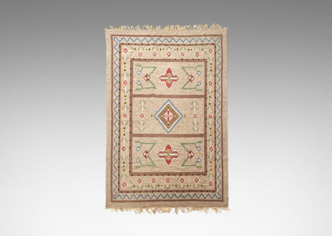 Gallery BAC olk motifs in green, red, yellow and blue on a background of marled pink, gray and cream yarns