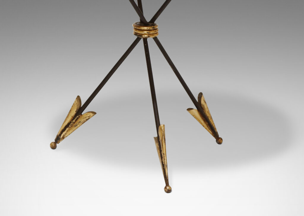 Gallery BAC tripod base in the form of three arrows joined at the center, supporting a round mirrored glass top edged in an airy looping border