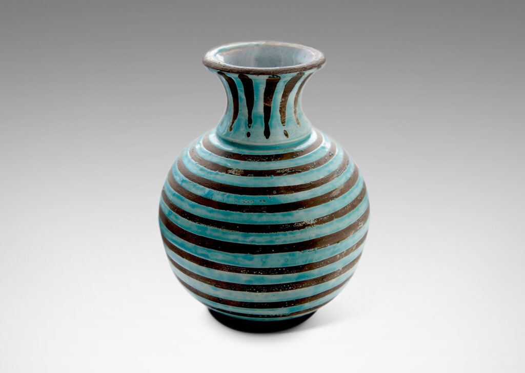 Gallery BAC spherical body with outstretched neck/mouth, perched on a low reveal foot, crafted in gray earthenware partially glazed in dimensionally thick pale aqua stripes