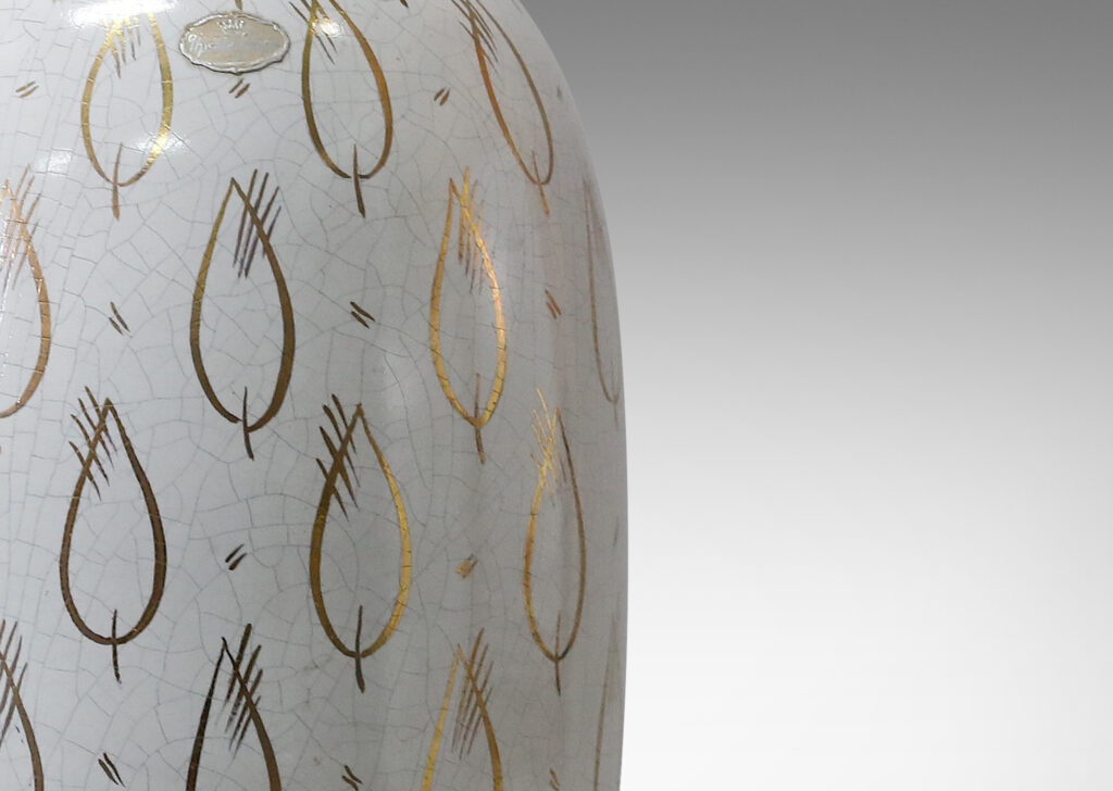 Gallery BAC ovoid form with white craquel finish and gilded leaf motifs in glazed earthenware