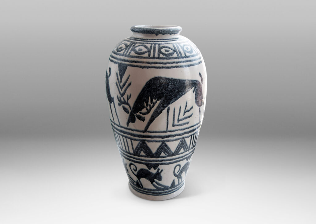 Gallery BAC base of ivory with indigo blue glazed registers of geometric forms and stylized Swedish wildlife, very possibly a playful Nordic interpretation of Geometric Period Greek vase painting