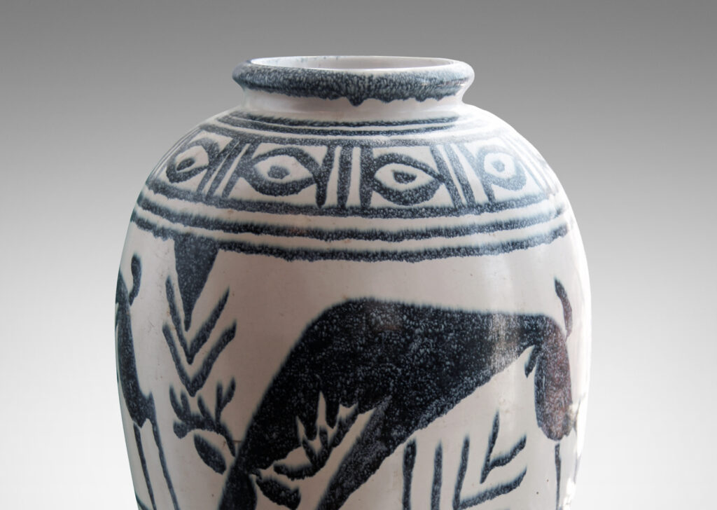 Gallery BAC base of ivory with indigo blue glazed registers of geometric forms and stylized Swedish wildlife, very possibly a playful Nordic interpretation of Geometric Period Greek vase painting