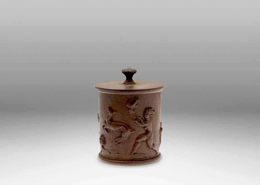 Gallery BAC ylindrical jar with a relief depicting the myth of Diana and Actaeon capped by a disk lid with rosette finial