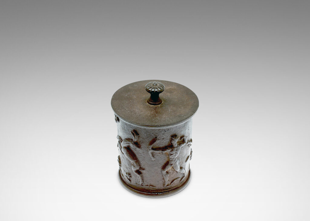 Gallery BAC ylindrical jar with a relief depicting the myth of Diana and Actaeon capped by a disk lid with rosette finial