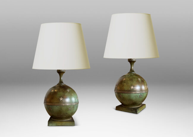 Gallery BAC globe bases with floating star ornaments mounted on square plinths and topped with coved stems