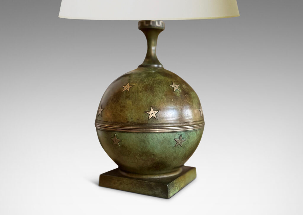 Gallery BAC globe bases with floating star ornaments mounted on square plinths and topped with coved stems