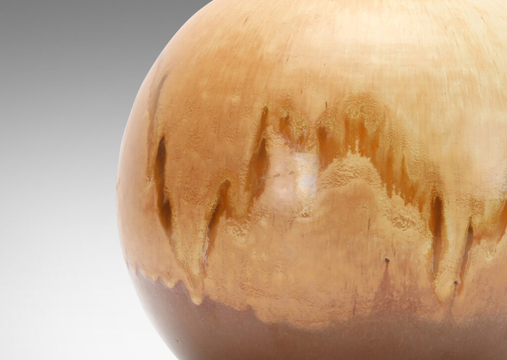 Gallery BAC globe form in stoneware with a flowing gold/acorn over brown glazing