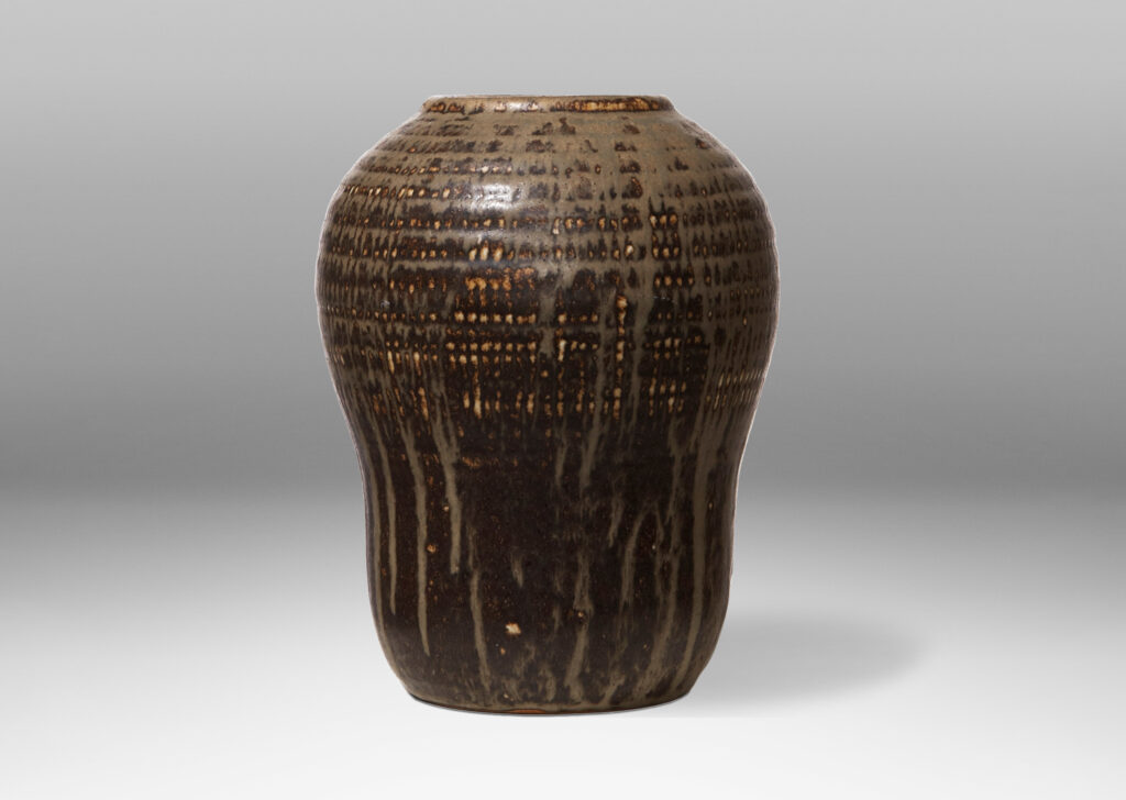 Gallery BAC organic form and stippled pattern around mouth and on shoulders in stoneware with sage green glaze flowing over brown