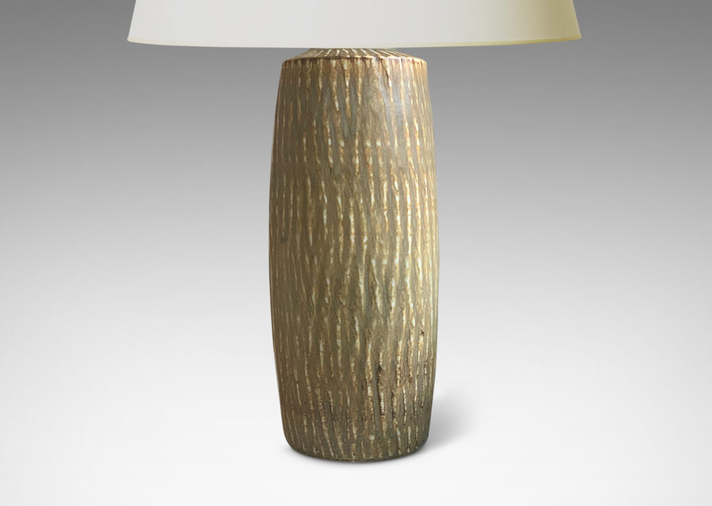 Gallery BAC swelling cylindrical form with carved gouged surface and flowing brown glaze over a pale gray