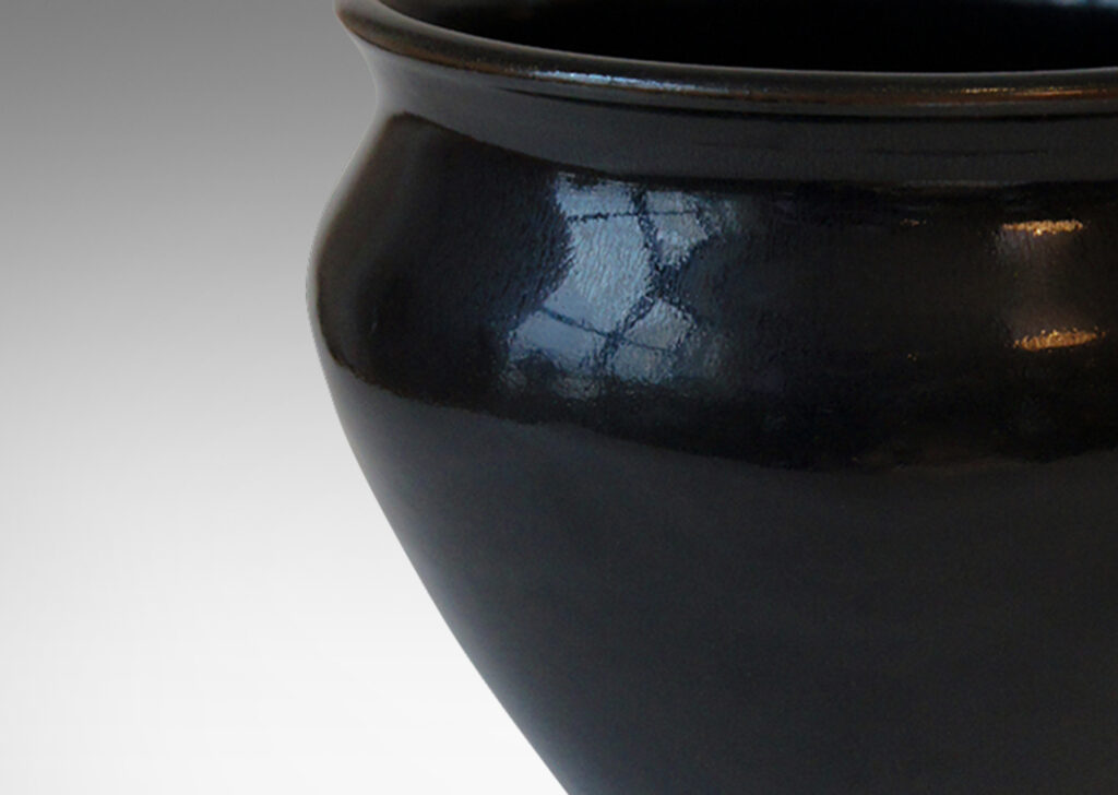 Gallery BAC tapered wide urn form with coved neck, in stoneware glazed in a deep black