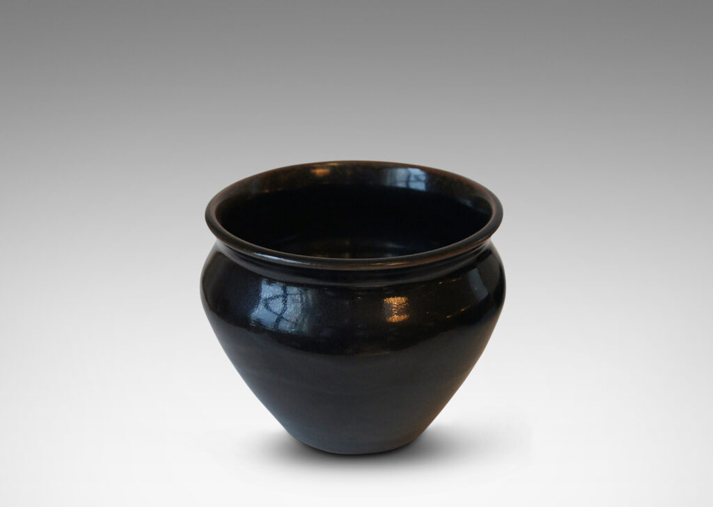 Gallery BAC tapered wide urn form with coved neck, in stoneware glazed in a deep black