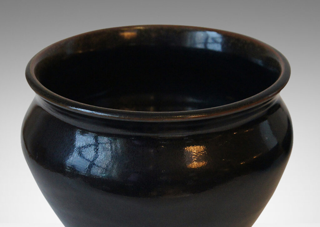 Gallery BAC tapered wide urn form with coved neck, in stoneware glazed in a deep black