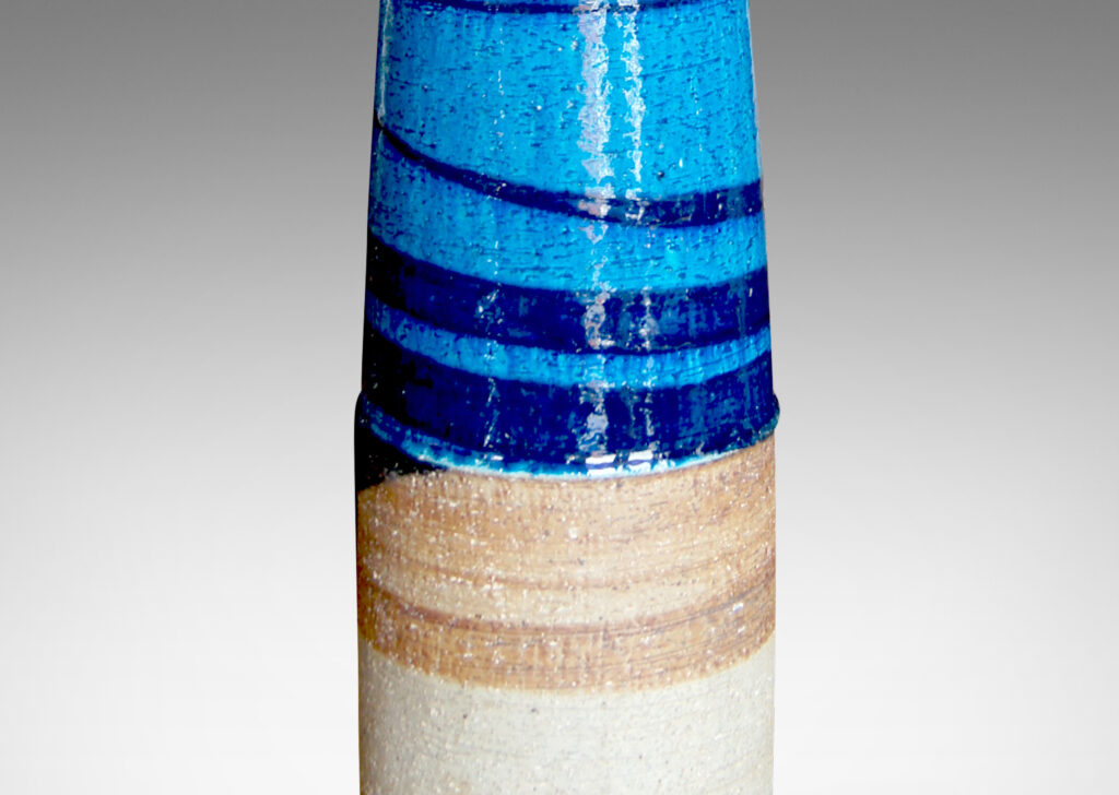 Gallery BAC tall swelling columnar form crafted in stoneware partially glazed in blue, turquoise, and matte brown