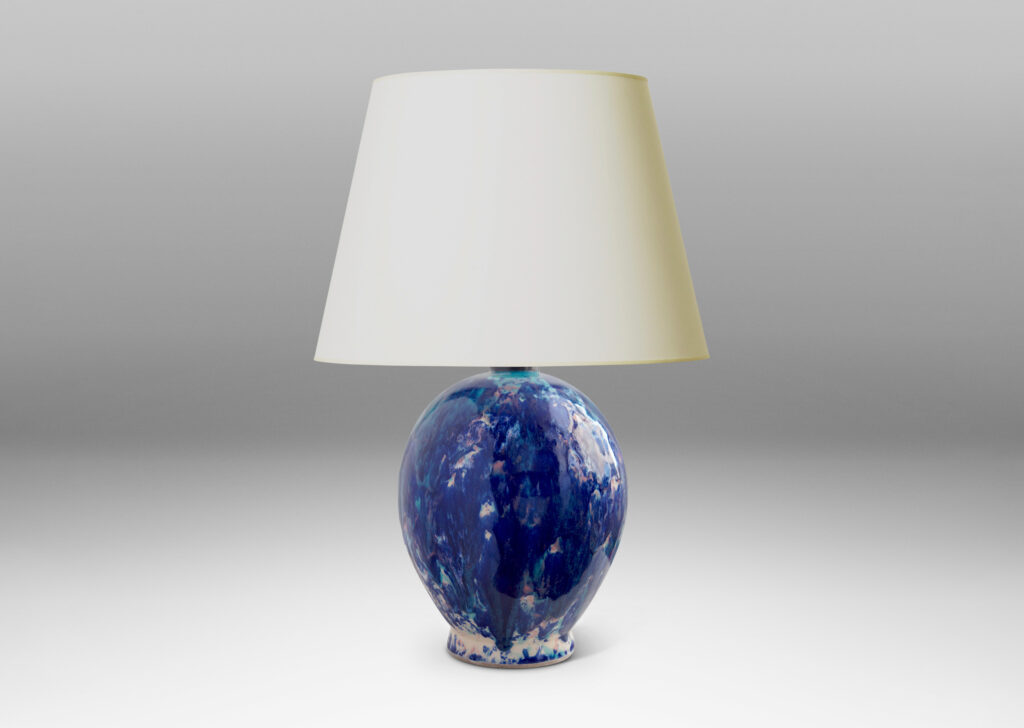 Gallery BAC oval form perched on a petite flange foot, in stoneware glazed in a gorgeous riot of indigo, cerulean and violet over a white base