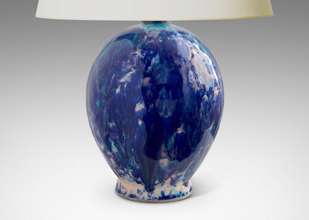 Gallery BAC oval form perched on a petite flange foot, in stoneware glazed in a gorgeous riot of indigo, cerulean and violet over a white base