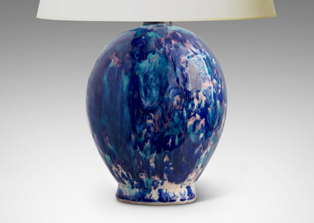 Gallery BAC oval form perched on a petite flange foot, in stoneware glazed in a gorgeous riot of indigo, cerulean and violet over a white base