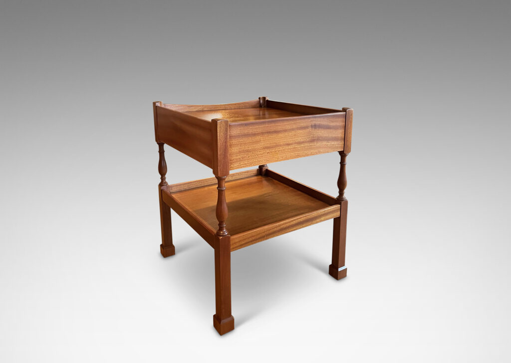 Gallery BAC rail edged top with drawer below and a railed shelf suspended on airy supports, masterfully crafted in ribbon-cut mahogany