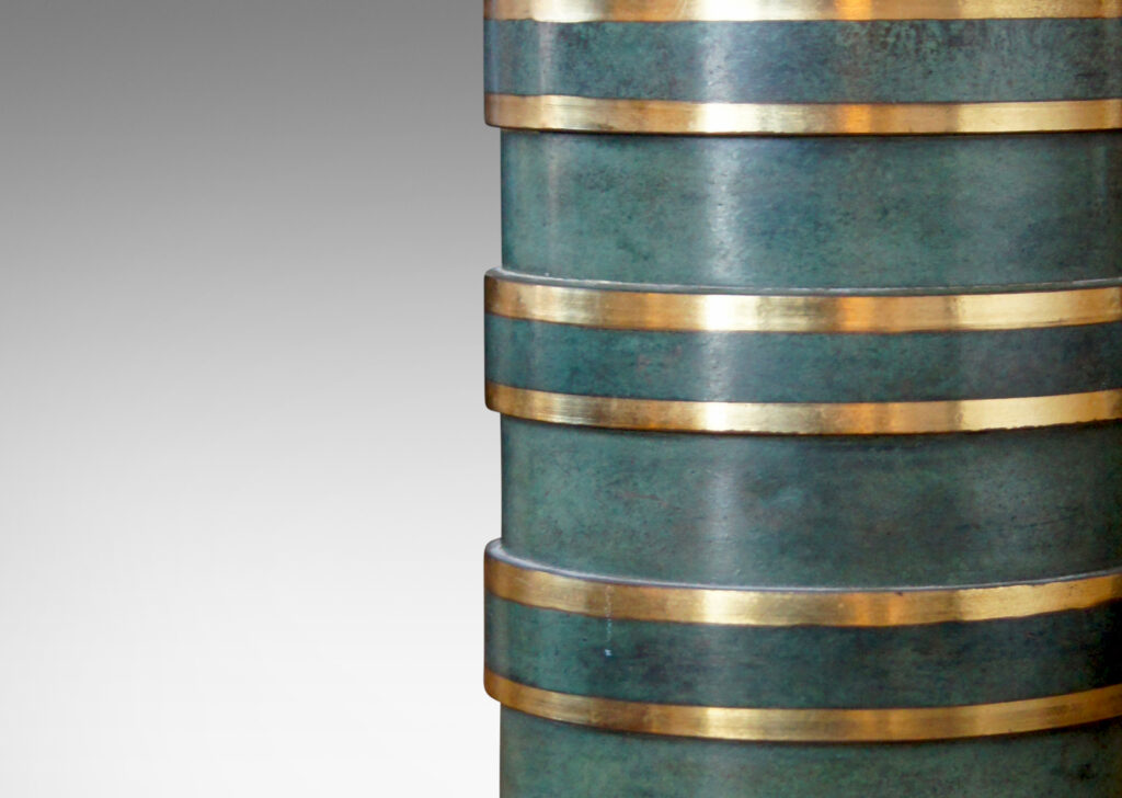 Gallery BAC ylindrical form divided into sections of alternating diameter like a coined column, crafted in bronze